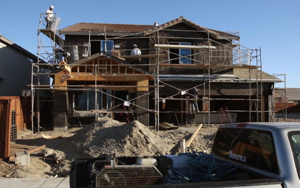 Workers build new homes in a subdivision