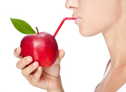 Girl drinks fruit juice from an apple