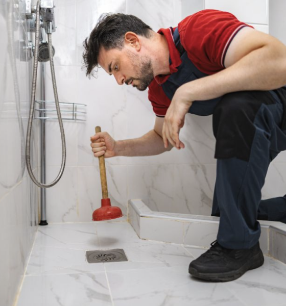 man plunging drain