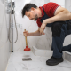 man plunging drain